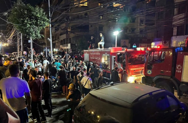 people gather near a site hit by what security sources said was a strike on beirut s southern suburbs lebanon july 30 2024 photo reuters