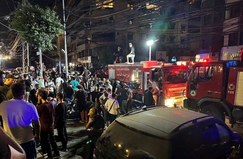people gather near a site hit by what security sources said was a strike on beirut s southern suburbs lebanon july 30 2024 photo reuters