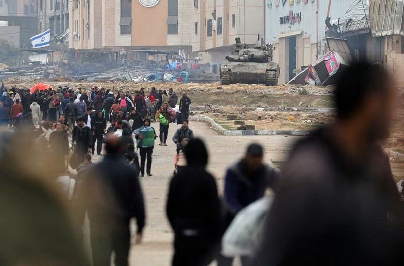 an israeli tank stands amid the rubble as palestinians fleeing khan younis move towards rafah in the southern gaza strip january 27 2024 photo reuters