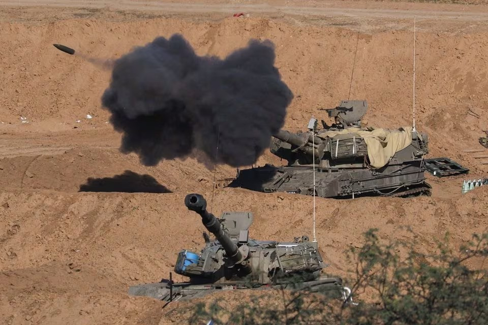 an israeli self propelled artillery unit fires as seen from southern israel december 26 2023 photo reuters