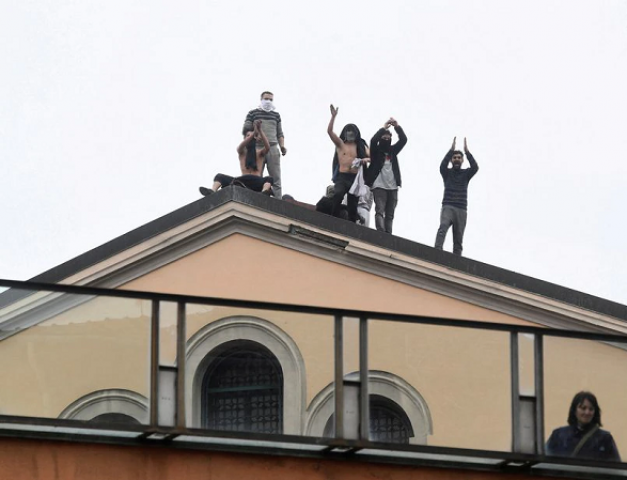 inmates are seen on the roof of the san vittore prison during a revolt after family visits were suspended due to fears over coronavirus contagion in milan italy march 9 2020 photo reuters inmates are seen on the roof of the san vittore prison during a revolt after family visits were suspended due to fears over coronavirus contagion in milan italy march 9 2020 photo reuters