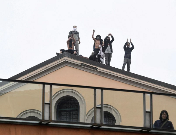 inmates are seen on the roof of the san vittore prison during a revolt after family visits were suspended due to fears over coronavirus contagion in milan italy march 9 2020 photo reuters