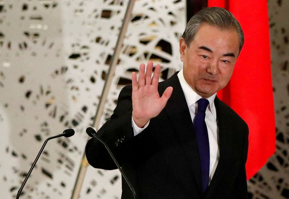 china s state councilor and foreign minister wang yi waves as he leaves a news conference in tokyo japan november 24 2020 photo reuters