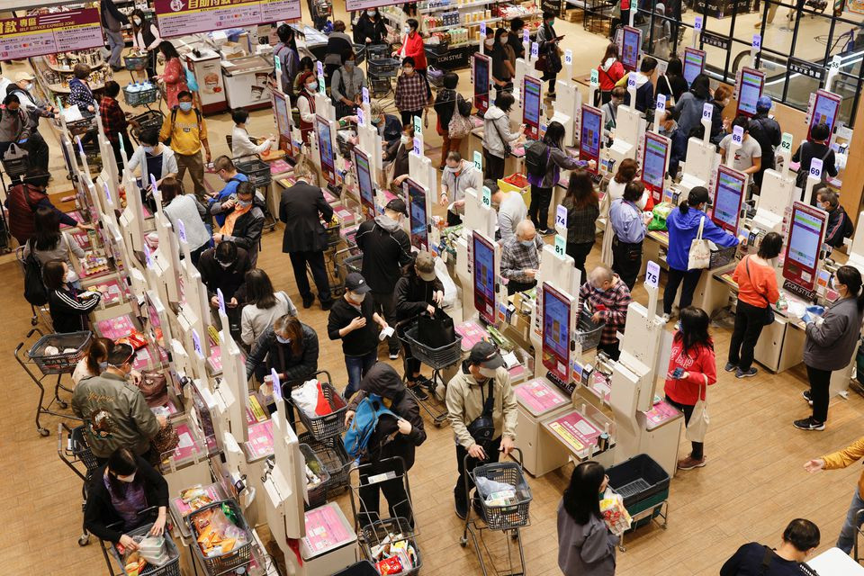 customers wearing face masks queue up to pay at a supermarket ahead of mass coronavirus disease covid 19 testing in hong kong china march 2 2022 reuters