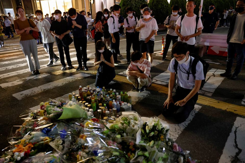 people pay respects at the site where late former japanese prime minister shinzo abe was shot while campaigning for a parliamentary election near yamato saidaiji station in nara western japan july 8 2022 reuters