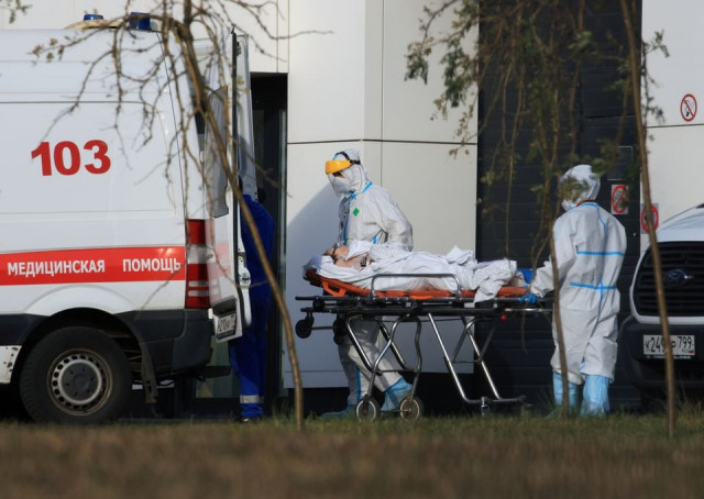 medical specialists transport a patient outside a hospital for people infected with the coronavirus disease covid 19 in moscow russia october 13 2021 photo reuters medical specialists transport a patient outside a hospital for people infected with the coronavirus disease covid 19 in moscow russia october 13 2021 photo reuters