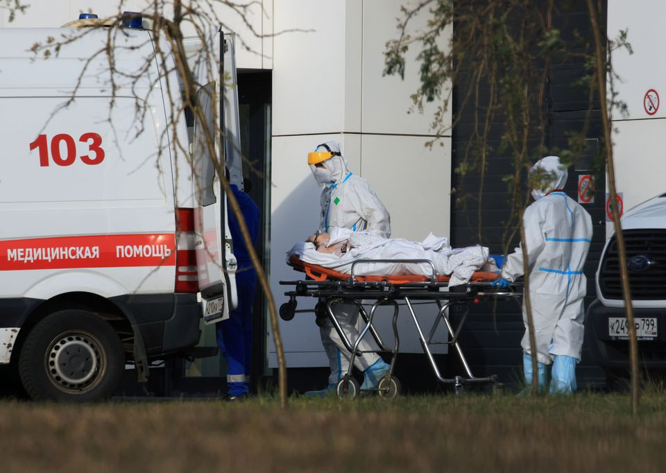 medical specialists transport a patient outside a hospital for people infected with the coronavirus disease covid 19 in moscow russia october 13 2021 photo reuters