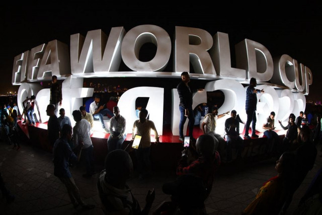 soccer football   fifa world cup qatar 2022 preview doha qatar   november 18 2022 fans take pictures with the fifa world cup logo on the corniche promenade ahead of the fifa world cup qatar 2022 reuters fabrizio bensch