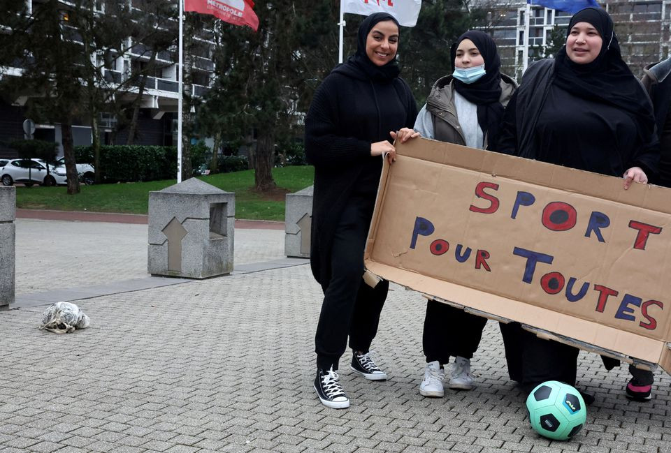 supporters of the women soccer team les hijabeuses gather in front of the city hall in lille as part of a protest as french senate examines a bill featuring controversial hijab ban in competitive sports in france february 16 2022 the slogan reads sport for all photo reuters