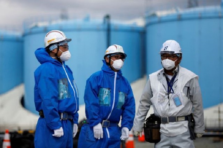 workers are seen in front of storage tanks for radioactive water at tokyo electric power co s tepco tsunami crippled fukushima daiichi nuclear power plant in okuma town fukushima prefecture japan february 18 2019 photo reuters