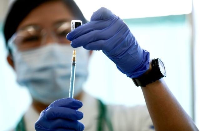 a medical worker fills a syringe with a dose of the pfizer biontech coronavirus disease covid 19 vaccine as japan launches its inoculation campaign at tokyo medical center in tokyo japan february 17 2021 photo reuters