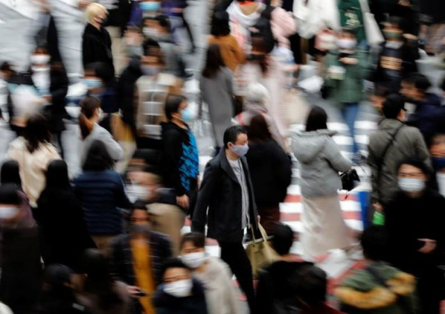 people wearing protective masks make their way amid the coronavirus disease covid 19 outbreak in tokyo japan photo reuters people wearing protective masks make their way amid the coronavirus disease covid 19 outbreak in tokyo japan photo reuters