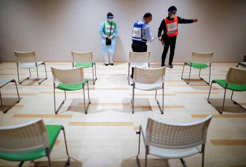 medical workers and a participant take part in a mock inoculation exercise as the local municipality prepares for coronavirus disease covid 19 mass vaccination campaign at a shopping mall in sakura east of tokyo japan march 5 2021 photo reuters file