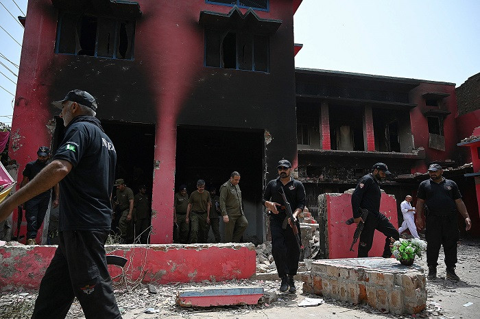 Police officials inspect a burnt Salvation Army church in Jaranwala on the outskirts of Faisalabad on August 17, 2023, PHOTO: AFP