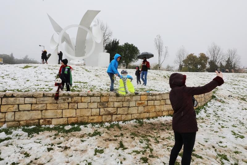 people play with snow and take selfies during a snowy morning in jerusalem february 18 2021 photo reuters
