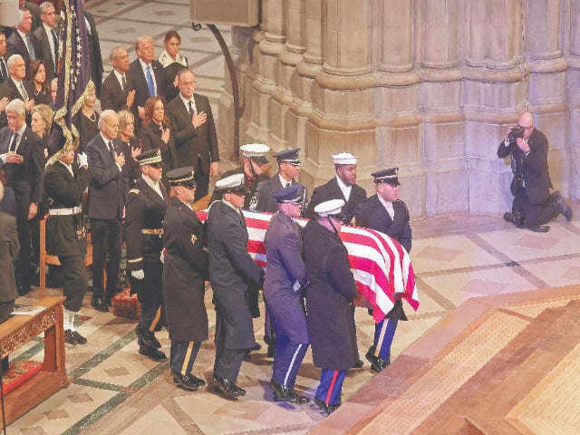 the remains of former us president jimmy carter are carried by an honor guard in washington dc photo afp