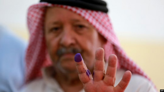 a jordanian man displays his ink stained finger after casting his vote in parliamentary elections at a polling station in al salt near the capital amman on sept ember 10 2024 photo afp a jordanian man displays his ink stained finger after casting his vote in parliamentary elections at a polling station in al salt near the capital amman on sept ember 10 2024 photo afp