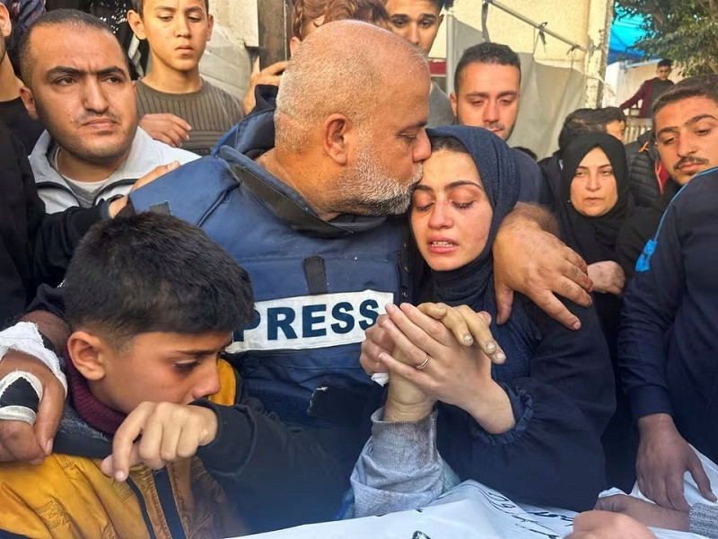Al Jazeera publisher Wael Al-Dahdouh hugs his daughter and son as they attend a wake of his son, Palestinian publisher Hamza Al-Dahdouh, after Hamza was killed in an Israeli strike, in Rafah in a southern Gaza Strip, Jan 7, 2024. PHOTO: REUTERS