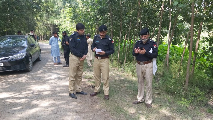 police officers inspect a crime scene after a fellow cop was killed in a targeted attacked in khyber pakhtunkhwa photo express file