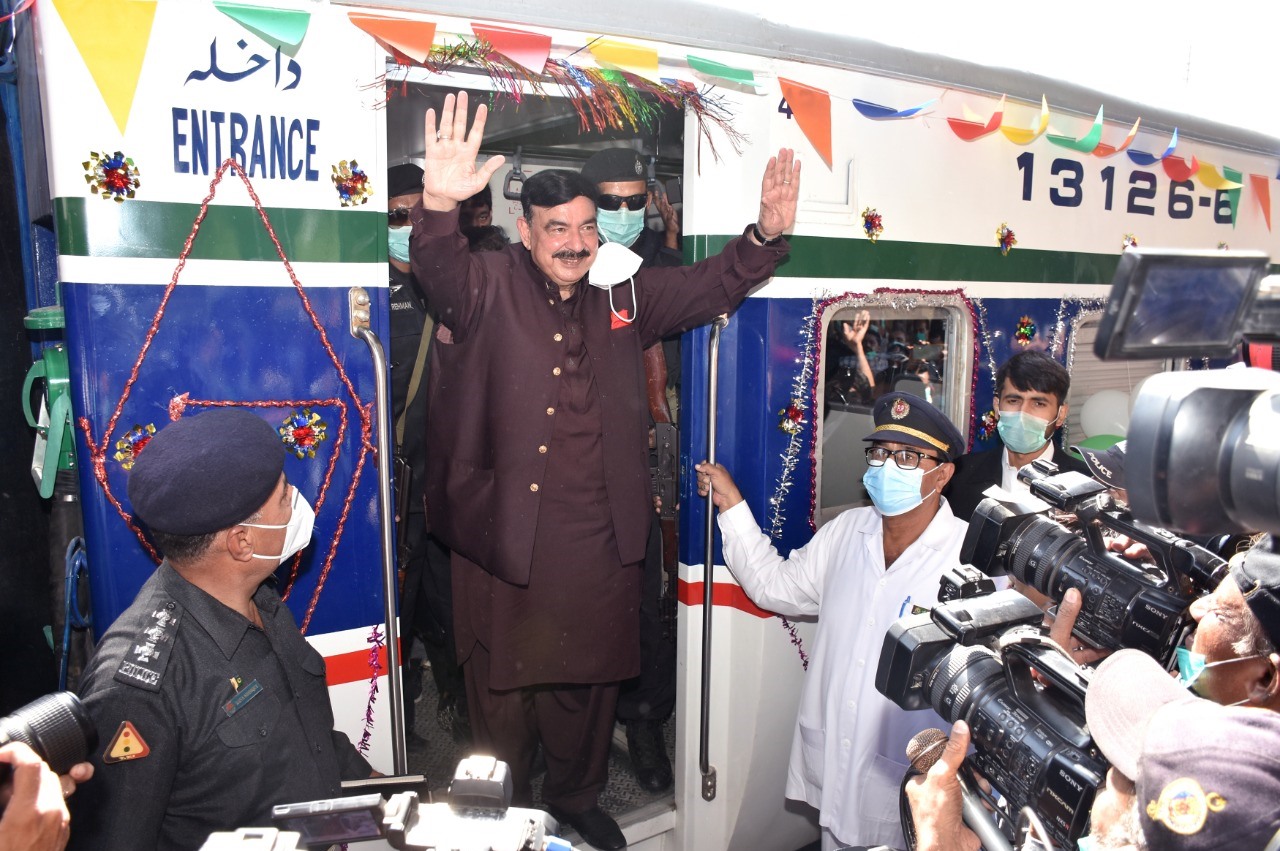 minister for railways sheikh rashid waves to a crowd of media personnel gathered for the inaugural ceremony of the karachi circular railway photo express