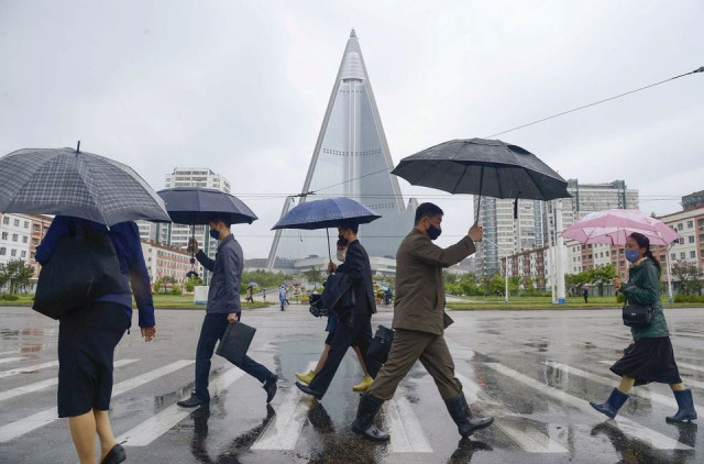 people wearing protective face masks walk amid concerns over the new coronavirus disease covid 19 in pyongyang north korea may 15 2020 in this photo released by kyodo reuters people wearing protective face masks walk amid concerns over the new coronavirus disease covid 19 in pyongyang north korea may 15 2020 in this photo released by kyodo reuters