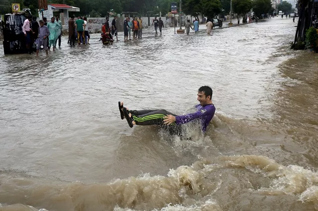 a man looses his balance while crossing a flooded street during monsoon rain as the outbreak of the coronavirus disease in karachi on august 27 2020 reuters a man looses his balance while crossing a flooded street during monsoon rain as the outbreak of the coronavirus disease in karachi on august 27 2020 reuters