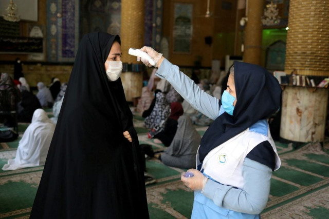 an iranian woman wearing a protective face mask checks the temperature of a worshipper before attending the friday prayers in qarchak jamee mosque following the outbreak of the coronavirus disease covid 19 in tehran province in qarchak iran june 12 2020 wana west asia news agency ali khara via reuters an iranian woman wearing a protective face mask checks the temperature of a worshipper before attending the friday prayers in qarchak jamee mosque following the outbreak of the coronavirus disease covid 19 in tehran province in qarchak iran june 12 2020 wana west asia news agency ali khara via reuters