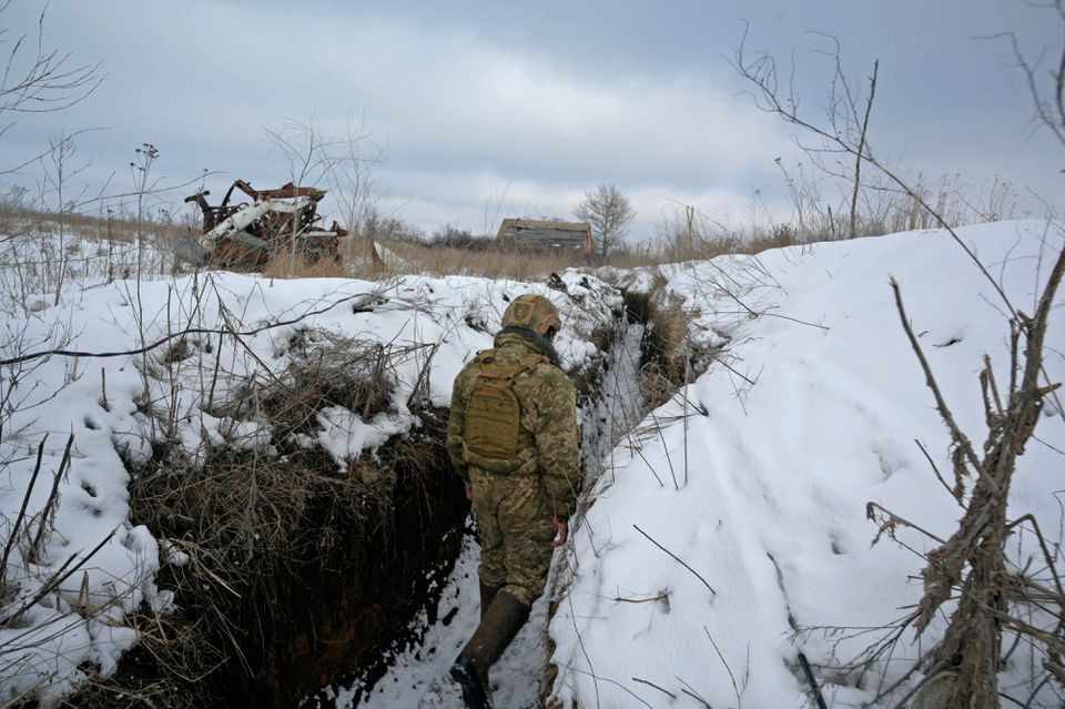 a service member of the ukrainian armed forces walks at combat positions near the line of separation from russian backed rebels in luhansk region ukraine february 6 2022 photo reuters
