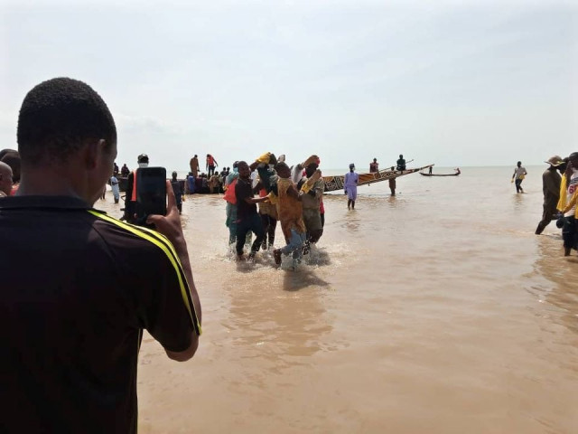 a man takes a picture as the body of one of the victims of a boat accident is being retrieved from the boat in kebbi nigeria photo reuters a man takes a picture as the body of one of the victims of a boat accident is being retrieved from the boat in kebbi nigeria photo reuters
