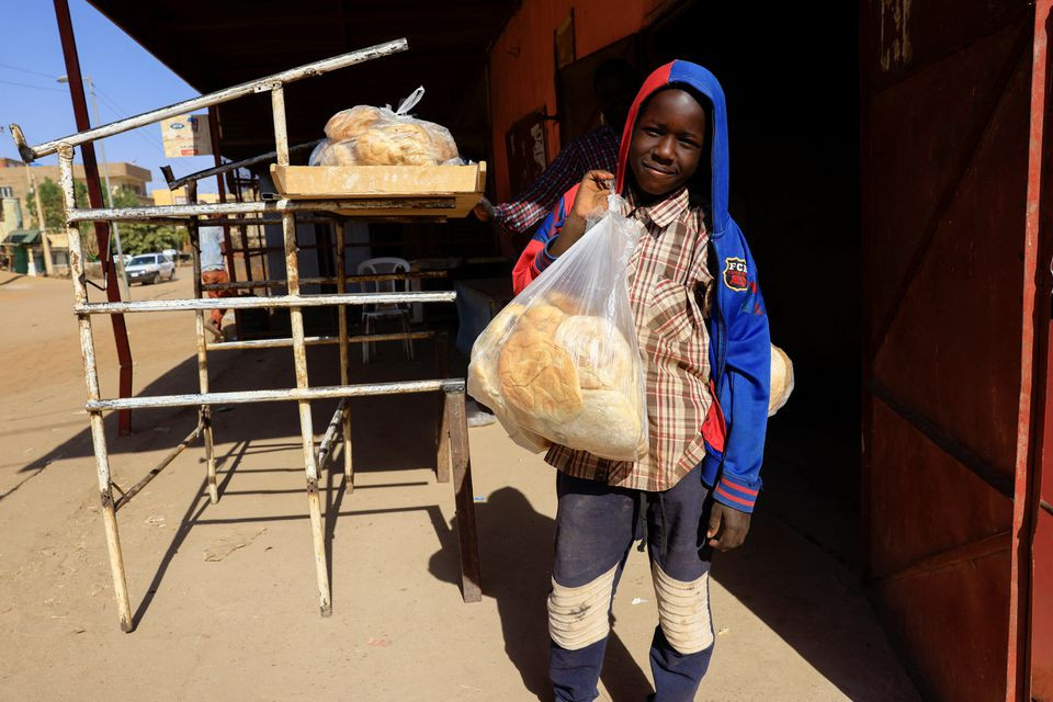 a boy carries a bag of bread in khartoum sudan february 21 2022 picture taken january 21 2022 photo reuters