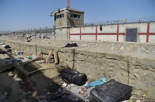 A suitcase and backpacks of Afghan people who were waiting to be evacuated are seen at the site of the August 26 twin suicide bombs. PHOTO: AFP