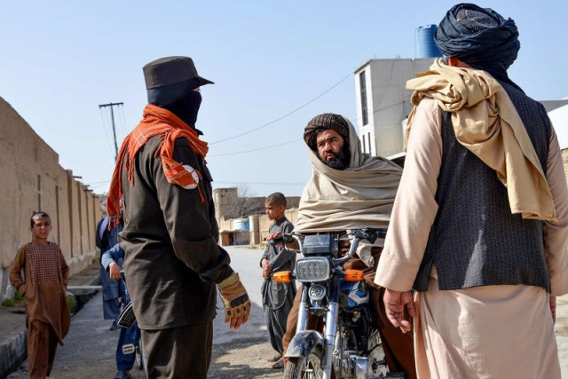 an afghan security personnel checks a motorbike rider near the site of a suicide bomb attack in kandahar on march 21 2024 photo afp an afghan security personnel checks a motorbike rider near the site of a suicide bomb attack in kandahar on march 21 2024 photo afp