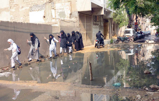 decaying infrastructure girls traverse a lane inundated with sewage in a karachi neighbourhood photo express decaying infrastructure girls traverse a lane inundated with sewage in a karachi neighbourhood photo express