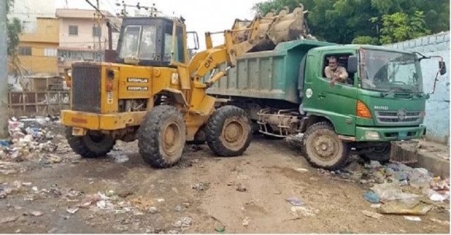 health hazard east district municipal corporation staff lifts garbage from a neighbourhood during post eid cleanup photo nni health hazard east district municipal corporation staff lifts garbage from a neighbourhood during post eid cleanup photo nni