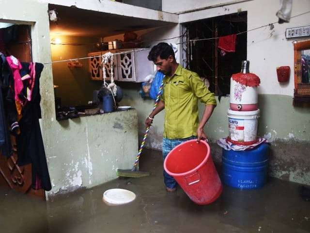 a resident tries to remove rains water from his house during heavy monsoon rains in karachi photo afp file a resident tries to remove rains water from his house during heavy monsoon rains in karachi photo afp file