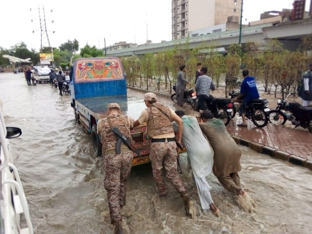 rangers personnel towing a truck in karachi as rain lashed many neighbourhoods in the metropolis on july 26 2020 photo express rangers personnel towing a truck in karachi as rain lashed many neighbourhoods in the metropolis on july 26 2020 photo express