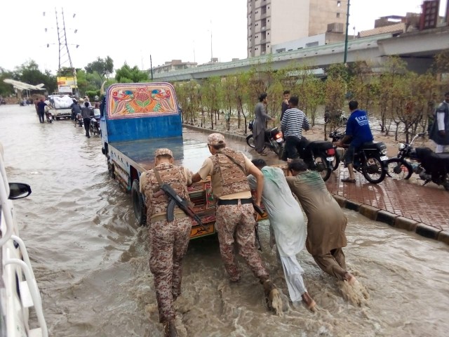 rangers personnel towing a truck in karachi as rain lashed many neighbourhoods in the metropolis on july 26 2020 photo express