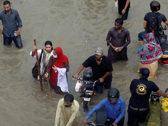 people wade through a flooded road during monsoon rain in karachi pakistan photo reuters people wade through a flooded road during monsoon rain in karachi pakistan photo reuters