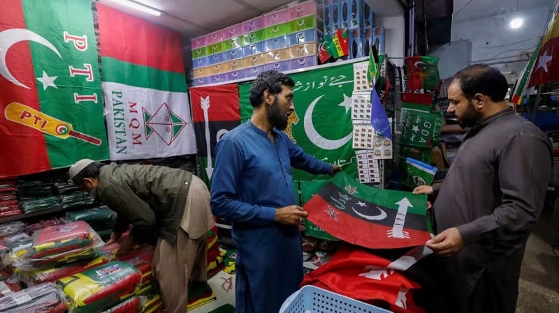 vendors selling flags of political parties in karachi photo reuters