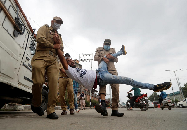 a shia muslim reacts as he is detained an iiojk policemen while trying to participate in a muharram procession in srinagar august 28 2020 photo reuters