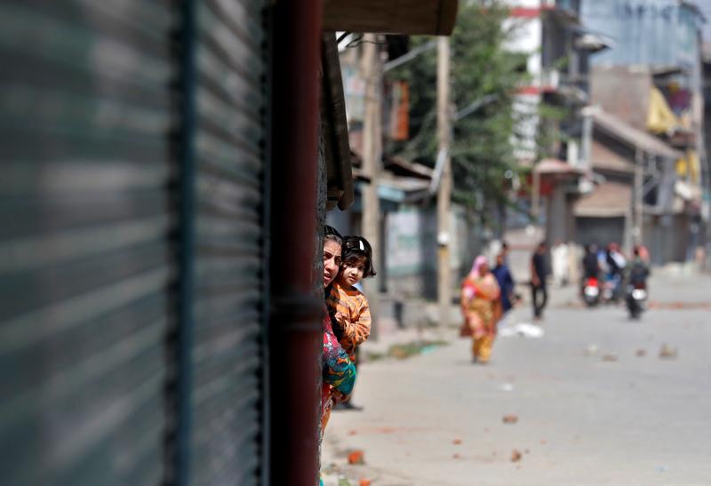 a kashmiri woman holds a girl as they watch a protest after a gun battle between freedom fighters and indian security forces in srinagar september 17 2020 photo reuters file