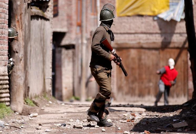 a kashmiri demonstrator r throws a stone towards an indian policeman during a protest against by polls in srinagar april 9 2017 photo reuters a kashmiri demonstrator r throws a stone towards an indian policeman during a protest against by polls in srinagar april 9 2017 photo reuters