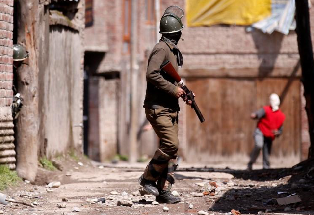 a kashmiri demonstrator r throws a stone towards an indian policeman during a protest against by polls in srinagar april 9 2017 photo reuters