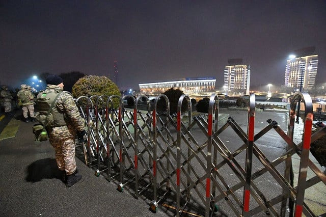 law enforcement officers stand guard in front of the mayor s office during protests triggered by fuel price increase in almaty kazakhstan january 5 2022 photo reuters law enforcement officers stand guard in front of the mayor s office during protests triggered by fuel price increase in almaty kazakhstan january 5 2022 photo reuters