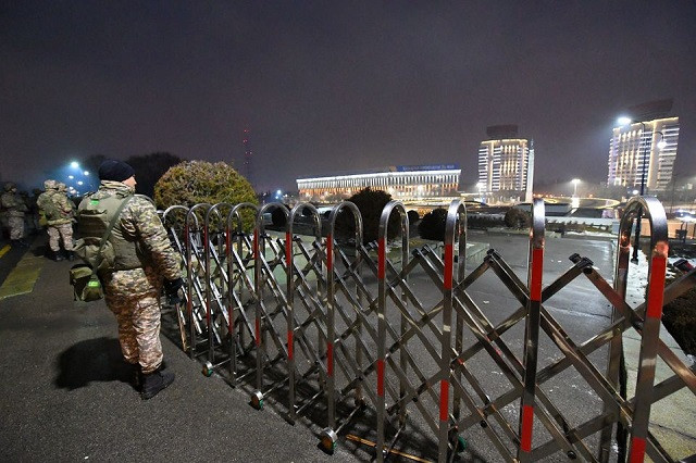 law enforcement officers stand guard in front of the mayor s office during protests triggered by fuel price increase in almaty kazakhstan january 5 2022 photo reuters