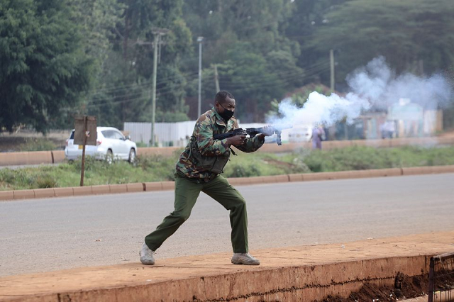 a police officers fires tear gas at protesters during clashes that erupted after a kenyan police officer shot dead several people and himself in a rampage attack in nairobi kenya december 7 2021 photo reuters a police officers fires tear gas at protesters during clashes that erupted after a kenyan police officer shot dead several people and himself in a rampage attack in nairobi kenya december 7 2021 photo reuters