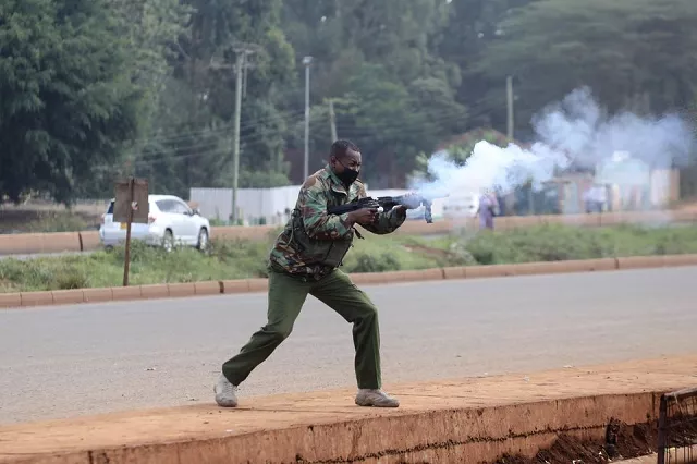 a police officers fires tear gas at protesters during clashes that erupted after a kenyan police officer shot dead several people and himself in a rampage attack in nairobi kenya december 7 2021 photo reuters a police officers fires tear gas at protesters during clashes that erupted after a kenyan police officer shot dead several people and himself in a rampage attack in nairobi kenya december 7 2021 photo reuters