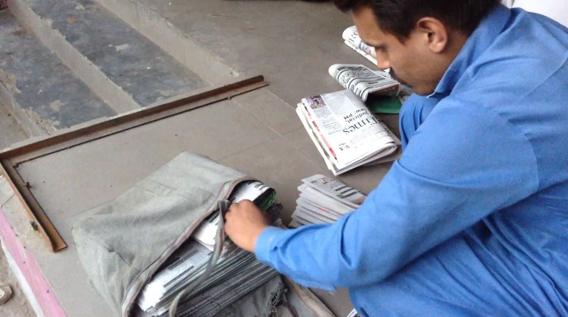 khalid khan prepares newspapers for delivery photo jahanzeb tahir