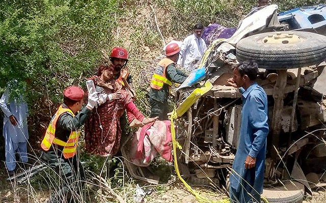 rescue workers carry an injured woman following a road accident in khushab district of punjab on saturday photo afp
