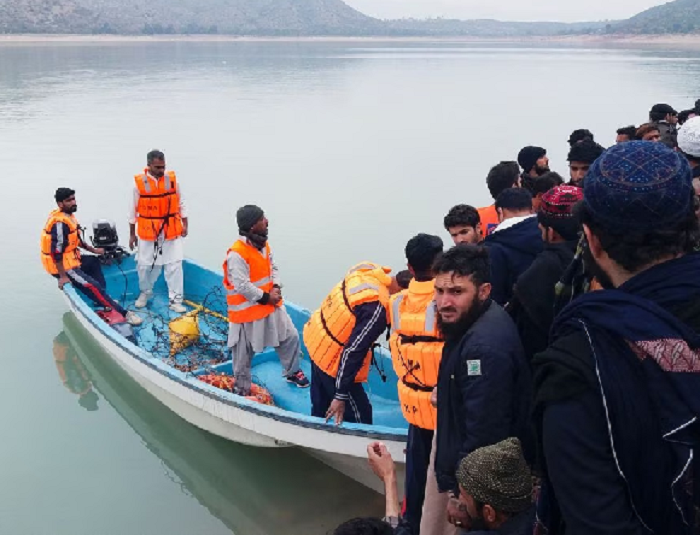 people and rescue workers gather after a boat carrying religious school students capsized in tanda lake in kohat pakistan january 29 2023 photo reuters